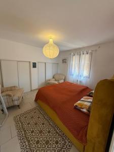 a bedroom with a bed and a chandelier at Charming Mountain Escape in Sospel, Perfect for Nature Lovers in Sospel