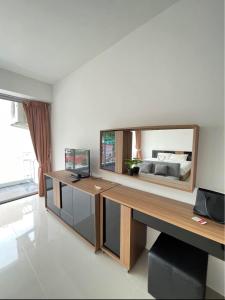 a room with a bed and a desk with a mirror at 10 minutes to reach the karon beach, with free swimming pool and gym, WIFI in Karon Beach +39 photos