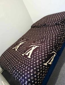 a black and white pillow with arrows on it at Oge's House in Bradford