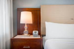 a lamp on a night stand next to a bed at Crowne Plaza Hotel Los Angeles Harbor, an IHG Hotel in San Pedro