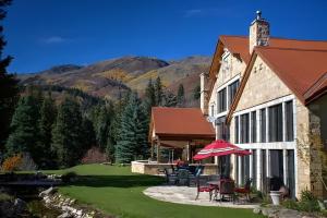 a house with a patio with chairs and an umbrella at Luxurious Mountain Retreat with Pool in Mound City