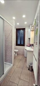 a bathroom with a shower and a toilet and a sink at La Laguna Incantata in Comacchio +38 photos
