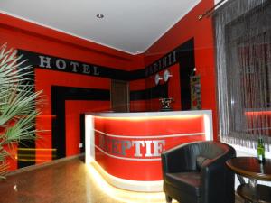 a hotel lobby with a large red wall at Hotel Marinii in Bucharest