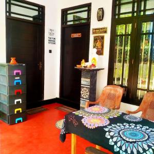 a room with a table and chairs and a door at White Angel in Mirissa +1 photo