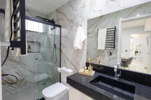a bathroom with a sink and a toilet and a shower at Studio Praia do jardim 1 208B in Angra dos Reis +22 photos