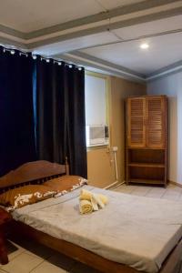 a bedroom with two beds and a window at Ace Travellers Inn- Palawan in Puerto Princesa City