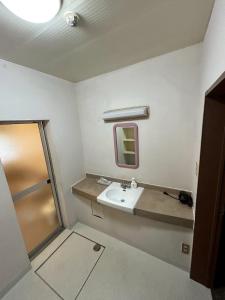 a bathroom with a sink and a shower at SamaSama Lodge Hakuba in Hakuba