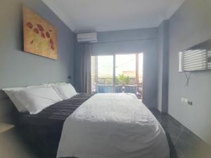 a bedroom with a large white bed with a window at la sublime in Taghazout