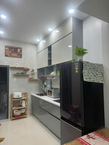 a kitchen with a black refrigerator in a room at Peach Peach Home 3 in Cú Lao Tân Nong +7 photos