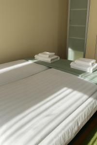 Postel nebo postele na pokoji v ubytování The Eleven Residence