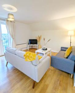 a living room with a couch and a table at Modern 2-Bed in Ipswich - Free Parking & Fast WiFi in Bramford