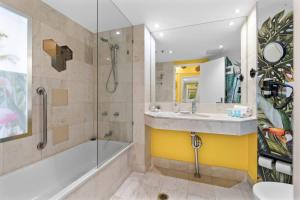a bathroom with a tub and a sink and a shower at Top Ocean View Artistic Apt in Gold Coast