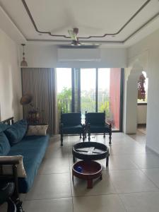 a living room with a couch and a table at Vintage home in Ahmedabad