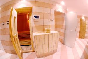 baño pequeño con fregadero y nevera en Al Liwan Suites, en Doha