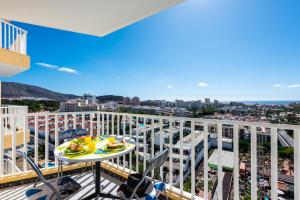 a balcony with a table and a view of the city at Beach apartment in Las Americas in Arona