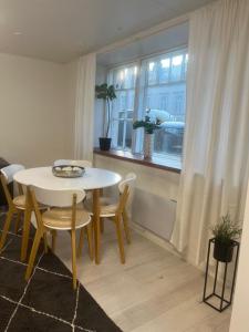 a table and chairs in a room with a window at Bright and spacious premise in Turku, Portsa in Turku +11 photos
