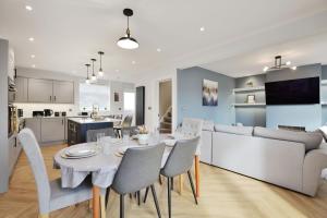 a dining room and living room with a table and chairs at Gated Driveway Walk To City Center 7 Mins New in Hereford