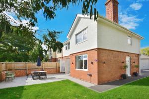 a house with a patio and a table in a yard at Gated Driveway Walk To City Center 7 Mins New in Hereford