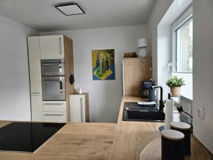 a kitchen with a stove and a counter top at Wangermeerglück in Wangerland