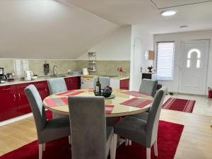 a kitchen and dining room with a table and chairs at Sanlej Apartman in Tuzla