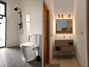 a bathroom with a toilet and a sink at Casa Kusuma in Prambanan