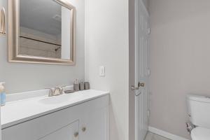 un bagno bianco con lavandino e specchio di Stylish 1-Bedroom Retreat in Fort Worth a Fort Worth