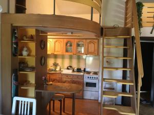 a kitchen with a bunk bed with a table and a tableablish at Apartment Ohridati lam in Ohrid