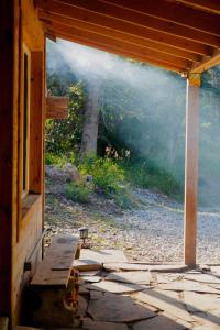 an open window of a house with a bench outside at Cozy Cabin Retreat in Midway in Mound City