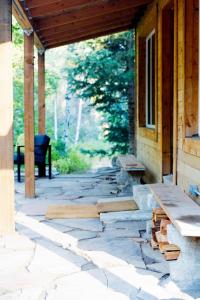 a porch with a bench on a house at Cozy Cabin Retreat in Midway in Mound City