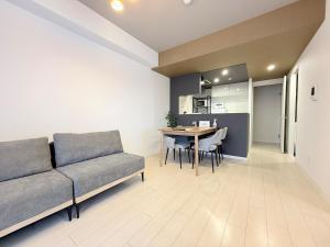 a living room with a couch and a table at Sun Court Nango-dori サンコート南郷通 1003 in Sapporo