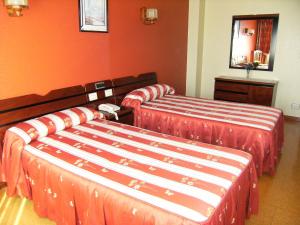 A bed or beds in a room at El Retiro