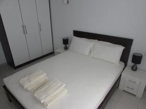 a bedroom with a white bed with two towels on it at BCV Private 2 Bed Apartment with Pool View Dunas Resort 7009 in Santa Maria