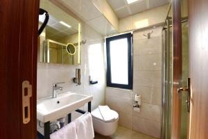 a bathroom with a sink and a toilet and a mirror at Hotel Öncü in Istanbul