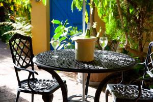 a black table with two glasses and a bottle of wine at John Bauer Pottery Studio in Cape Town +71 photos