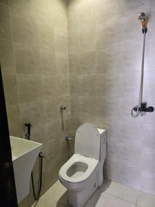 a bathroom with a toilet and a sink at Marasi in AlUla