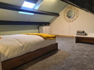 a bedroom with a bed and a window and a sink at Cosy Townhouse Within Caernarfon's Old Town Walls in Caernarfon