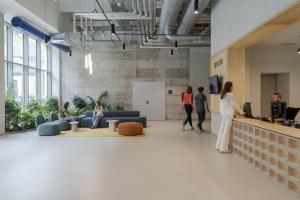 a group of people in an office lobby with a woman at aparto Florence Manifattura in Florence