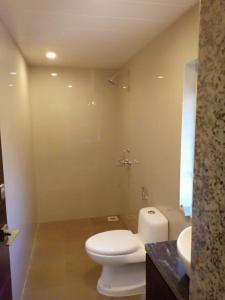 a bathroom with a white toilet and a sink at Natures Nest In Marine Gardens in Candolim +27 photos