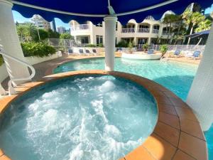 a hot tub in the middle of a swimming pool at Studio Bliss by the Sea in Gold Coast
