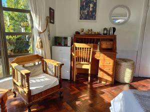 a room with a desk and two chairs and a table at John Bauer Pottery Studio in Cape Town