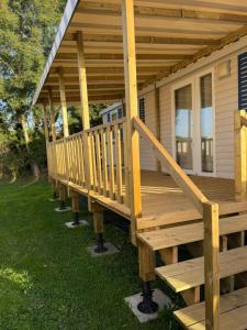 a wooden porch on a tiny house at L'Eleganzia Piscines et nature en Normandie in Litteau