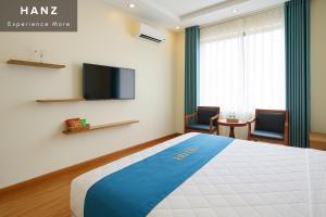 a hotel room with a bed and a flat screen tv at S79 Noi Bai Airport Hotel in Hanoi