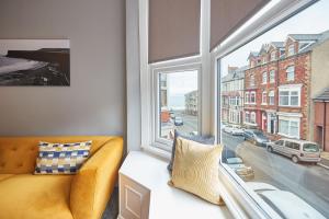 a living room with a couch and a large window at Seaside Retreat 2Bed Apartment Central Saltburn in Saltburn-by-the-Sea