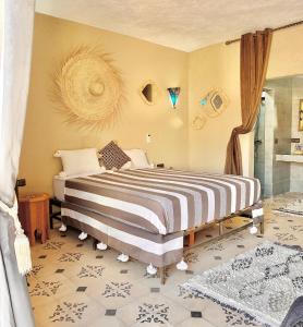 a bedroom with a large bed in a room at Riad Maj Nia House in Essaouira +59 photos