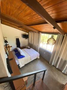 a bedroom with a bed in a room with a window at Chalés Lavras de Minas - Belém in Ouro Preto +15 photos