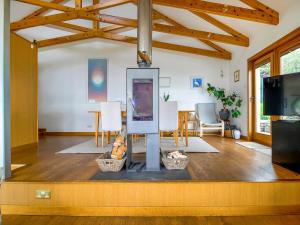 a living room with a table and a tv at Shore House in Kilcreggan