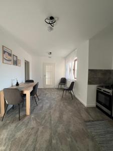 a living room with a table and chairs and a stove at Colt de Apuseni Guesthouse in Curăţele +19 photos
