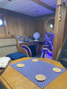 a dining room with a table and some chairs at LOTOSS ex ice class Pilot ship in Engure +31 photos