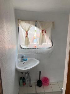a bathroom with a sink and a window at LOTOSS ex ice class Pilot ship in Engure