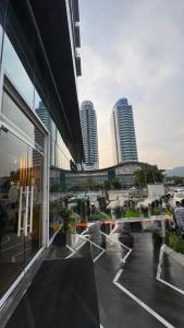 a building with a view of a city with tall buildings at The Signature Apartments-Elysium Tower Facing Centaurus Mall Islamabad in Islamabad